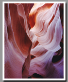 Sandstone striations glow brightly inside the narrow slot canyon of Lower Antelope Canyon.