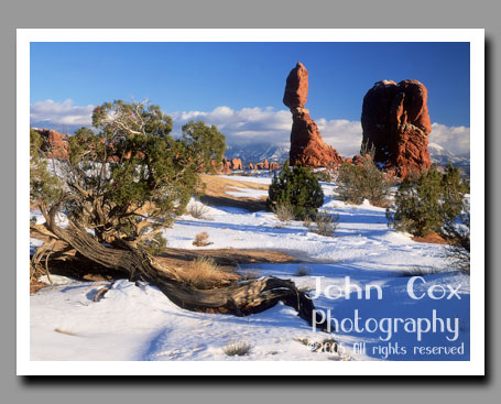 Snow surrounds Balanced Rock in Arches National Park, Utah.