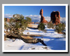 Snow surrounds Balanced Rock in Arches National Park, Utah.