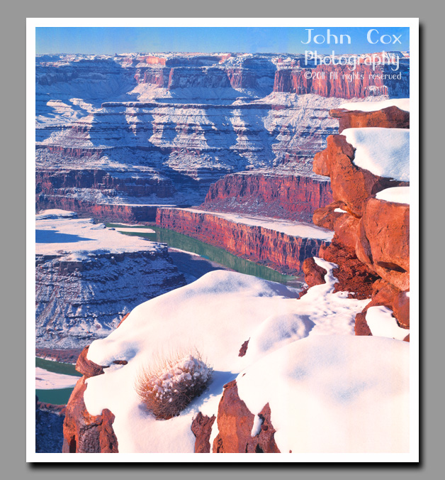 Freshly fallen snow covers the red canyon walls below Dead Horse Point in Utah.