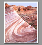 Petrified sands form a wave of pink and white swirls in Valley of Fire State Park, Nevada.