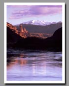 The Fisher Towers reflect in the Colorado River in Utah.