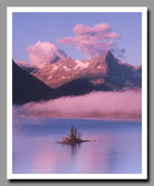 The Grand Tetons reflect in the crystalline waters of a small pond in Grand Teton National Park, Wyoming.