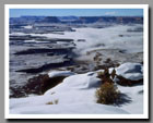 Low clouds fill the canyons of the green River below the Green River Overlook in Canyonlands National Park, Utah.