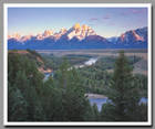 The freshly dusted Grand Teton glows in the light of the rising soon as the Snake River meanders along its way in the foreground.