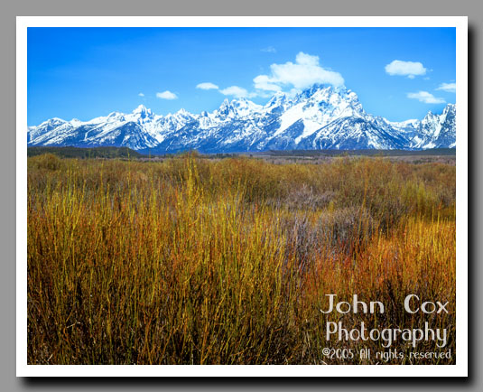 An vast prarie leads to the base of the snow-capped Grand Tetons in Grand Teton National Park, Wyoming.