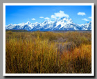An vast prarie leads to the base of the snow-capped Grand Tetons in Grand Teton National Park, Wyoming.