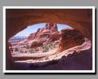 A sandstone landscape viewed through Tower Arch in Arches National Park, Utah.