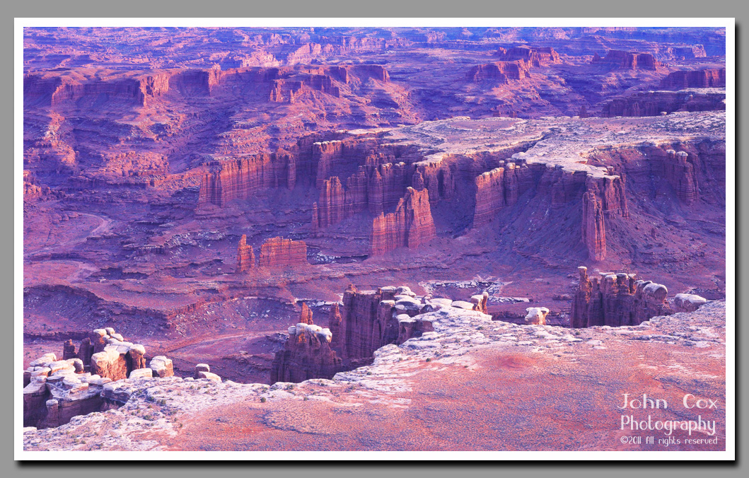 A white rim outlines the Island in the Sky plateau from the red spires and walls below.