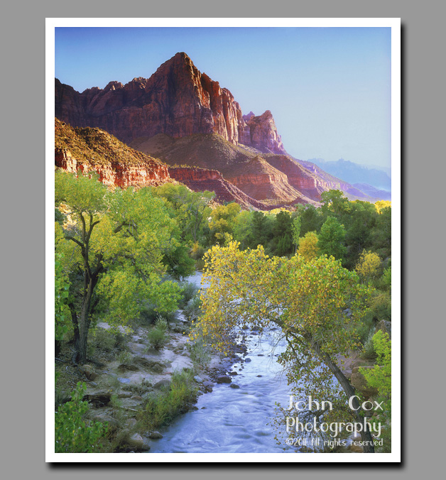 The Watchman towers majestically over the virgin river in Zion National Park, Utah.